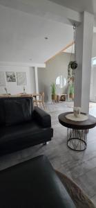 a living room with a black couch and a table at Casa Sole in Murg +12 photos