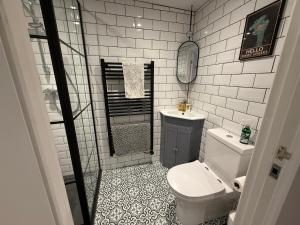 a small bathroom with a toilet and a sink at Oak Lodge in Hambledon +6 photos