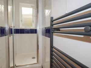 a bathroom with a shower and a glass door at Newseal House in St Austell +14 photos