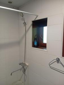 a shower in a bathroom with a mirror and a window at Дом in Shorzha +10 photos