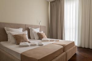 a large bed with towels on it in a room at Azamra in Uman +29 photos