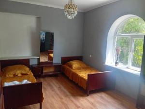 a bedroom with two beds and a window at Дом in Shorzha