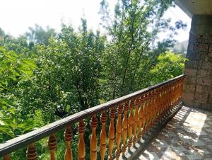 a wooden fence with trees in the background at Дом in Shorzha