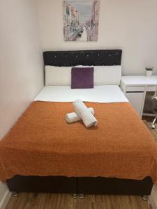 a bedroom with a bed with two towels on it at Cosy Private Bedrooms in Euston Station in London