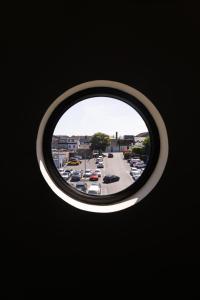 a view of a parking lot through a circular window at The Yard Dungarvan in Dungarvan