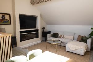 a living room with a couch and a tv at The Yard Dungarvan in Dungarvan