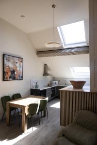 a kitchen with a table and some chairs in a room at The Yard Dungarvan in Dungarvan