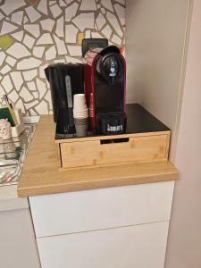 a wooden drawer with a coffee maker on top of a counter at A Casa Mia in Floridia