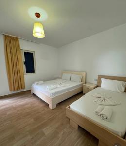 a room with two beds and a window at Gregor Villa in Asim Zeneli