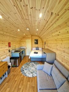 a bedroom with a bed and a couch in a room at The Star Inn in Dylife