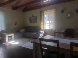 a living room with a couch and a table at Rozītes in Cesvaine