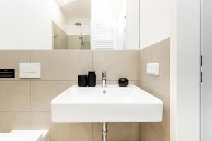 a bathroom with a white sink and a mirror at Global Living Chemnitz Rosenhof in Chemnitz +123 photos