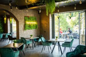 a restaurant with tables and chairs and people sitting at tables at Casa Braneana in Bran