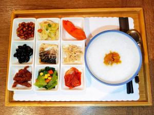 a tray with a plate of food and a drink at Energy Inn in Taipei