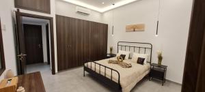 a bedroom with a bed and a wooden door at Allure Suites in Larnaca