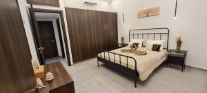 a bedroom with a bed and a wooden door at Allure Suites in Larnaca
