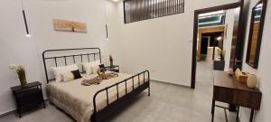 a bedroom with a bed and a desk in a room at Allure Suites in Larnaca