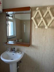 a bathroom with a sink and a mirror at Villa Keti in Velipojë