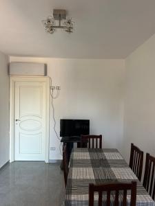a dining room with two tables and a television at Villa Keti in Velipojë