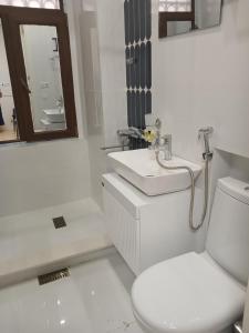a white bathroom with a sink and a toilet at Hotel White Neptun Georgia Tbilisi in Tbilisi City +53 photos