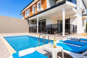 a villa with a swimming pool and a house at Villa Azalea 2 in Ortaca