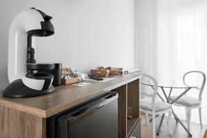 a kitchen with a table with a mixer and a chair at Hostal Puente de Hierro in Logroño