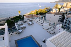 an aerial view of a patio with chairs and tables at Palatino Hotel in Zakynthos
