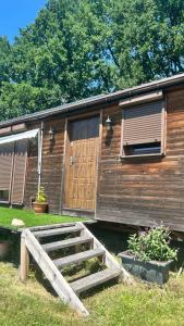 a wooden cabin with a wooden ramp in front of it at Luční domek in Protivín +7 photos