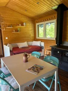 a room with a bed and a table and chairs at Luční domek in Protivín