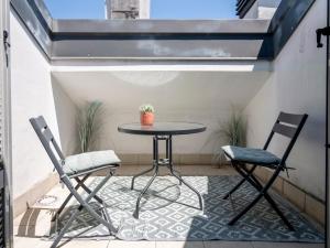 a small table and two chairs on a patio at NoLo Uptown Milano in Milan +10 photos
