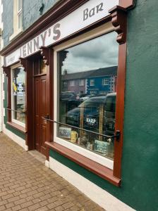a store front window of a lawneys bar on a street at Jennys Bar in Mullagh