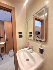 a bathroom with a sink and a mirror at ReLax havanaa in Cairo +28 photos