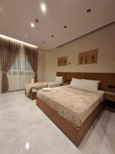 a bedroom with two beds and a large window at ReLax havanaa in Cairo