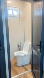 a white toilet in a bathroom with a window at BooGoo yurt camp in Song-Kul