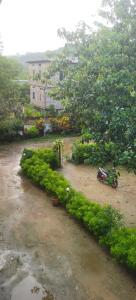 a motorcycle parked on a dirt road next to a river at ChangGhor in Digru