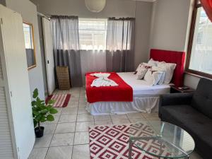 a small room with a bed and a couch at Great Choice BnB in Goodwood