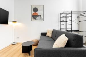a living room with a couch and a table at Global Living Chemnitz Rosenhof in Chemnitz