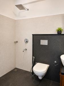 a bathroom with a toilet and a sink at Aditi in Thekkady +17 photos