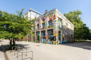 a building covered in colorful art on the side of it at Global Living Chemnitz Rosenhof in Chemnitz