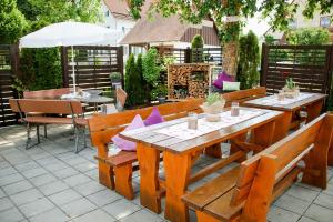 a patio with two wooden benches and a table at Ferienhaus Alb-Traum in Hayingen