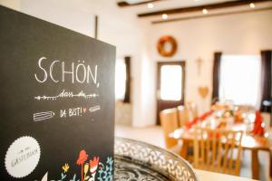 a chalkboard sign on a table in a restaurant at Ferienhaus Alb-Traum in Hayingen