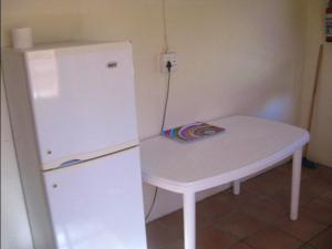 a small white table next to a white refrigerator at Korentepoort Dam in Riversdale