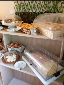 a shelf with bread and eggs and other food at Hotel Isidora in Loutrós +49 photos