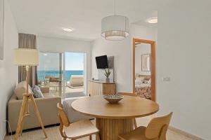 a living room with a table and a couch at Callao Beach 8 in Arrieta