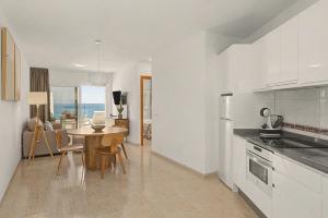 a kitchen and dining room with a table and chairs at Callao Beach 8 in Arrieta +19 photos