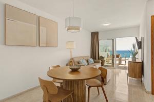 a living room with a table and a couch at Callao Beach 8 in Arrieta