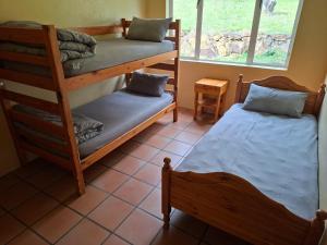 a room with two bunk beds and a window at Korentepoort Dam in Riversdale