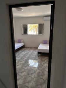 a view of a room with two beds and a window at MG Zarzis 3 in Zarzis