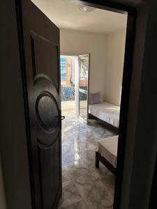 an open door to a bedroom with a bed and a bed sqor at MG Zarzis 3 in Zarzis