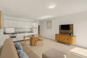 a living room with a couch and a table and a kitchen at Callao Beach 5 in Arrieta